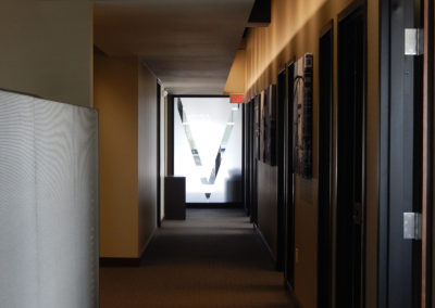 dimly lit hallway with branded wall